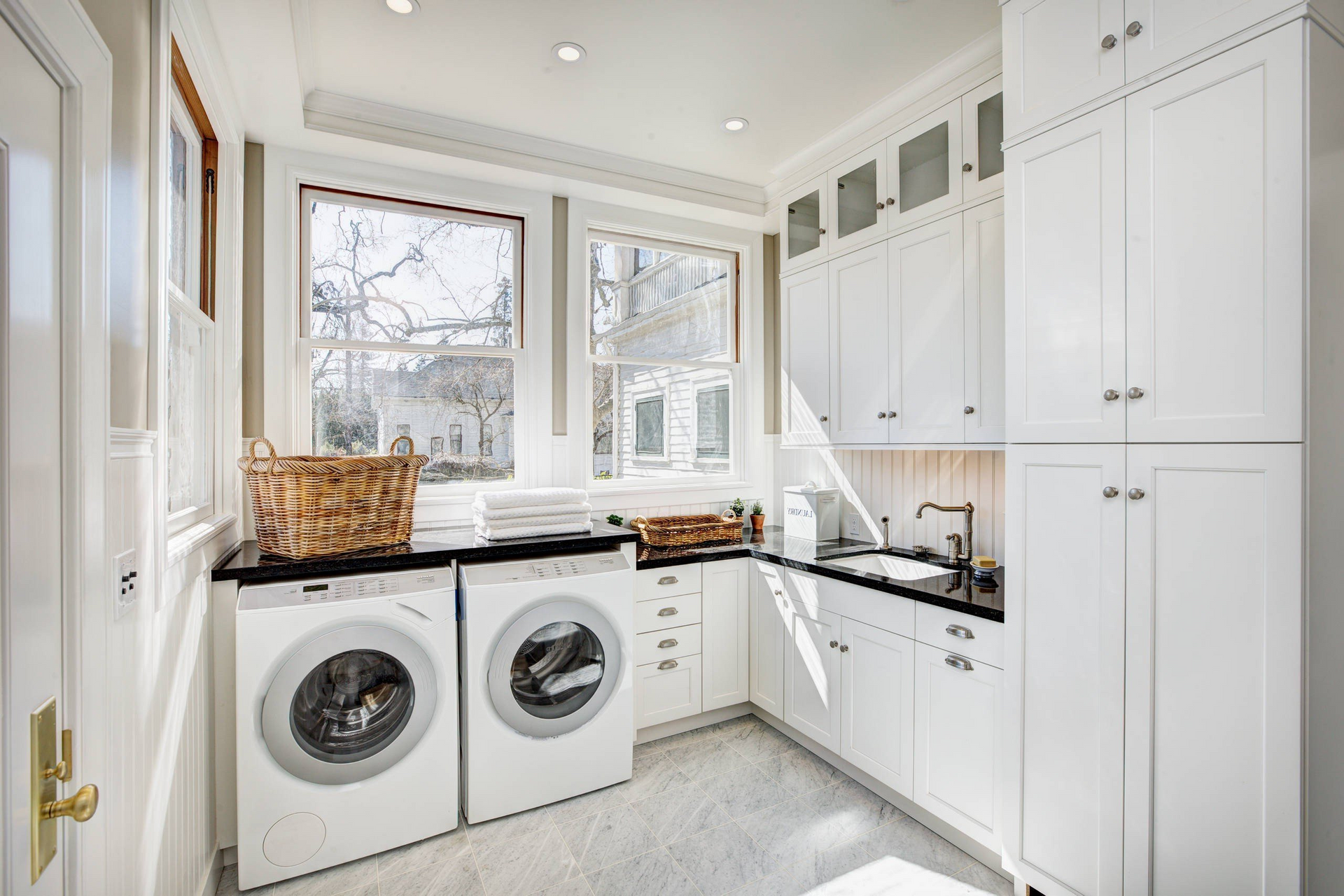 A laundry room with a washer and dryer and a sink.