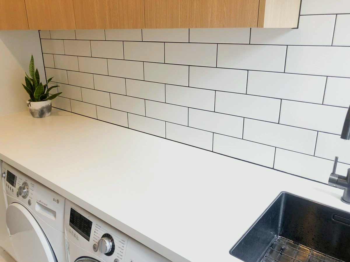 A laundry room with a sink, washer and dryer.