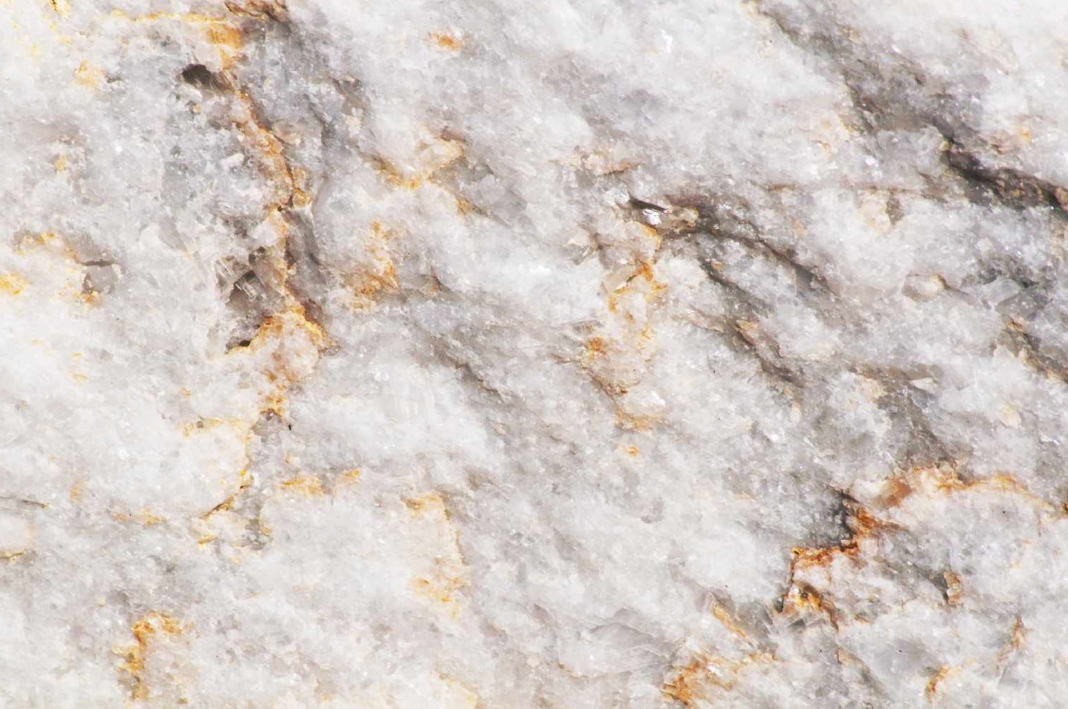 White marble with gray and gold veins.