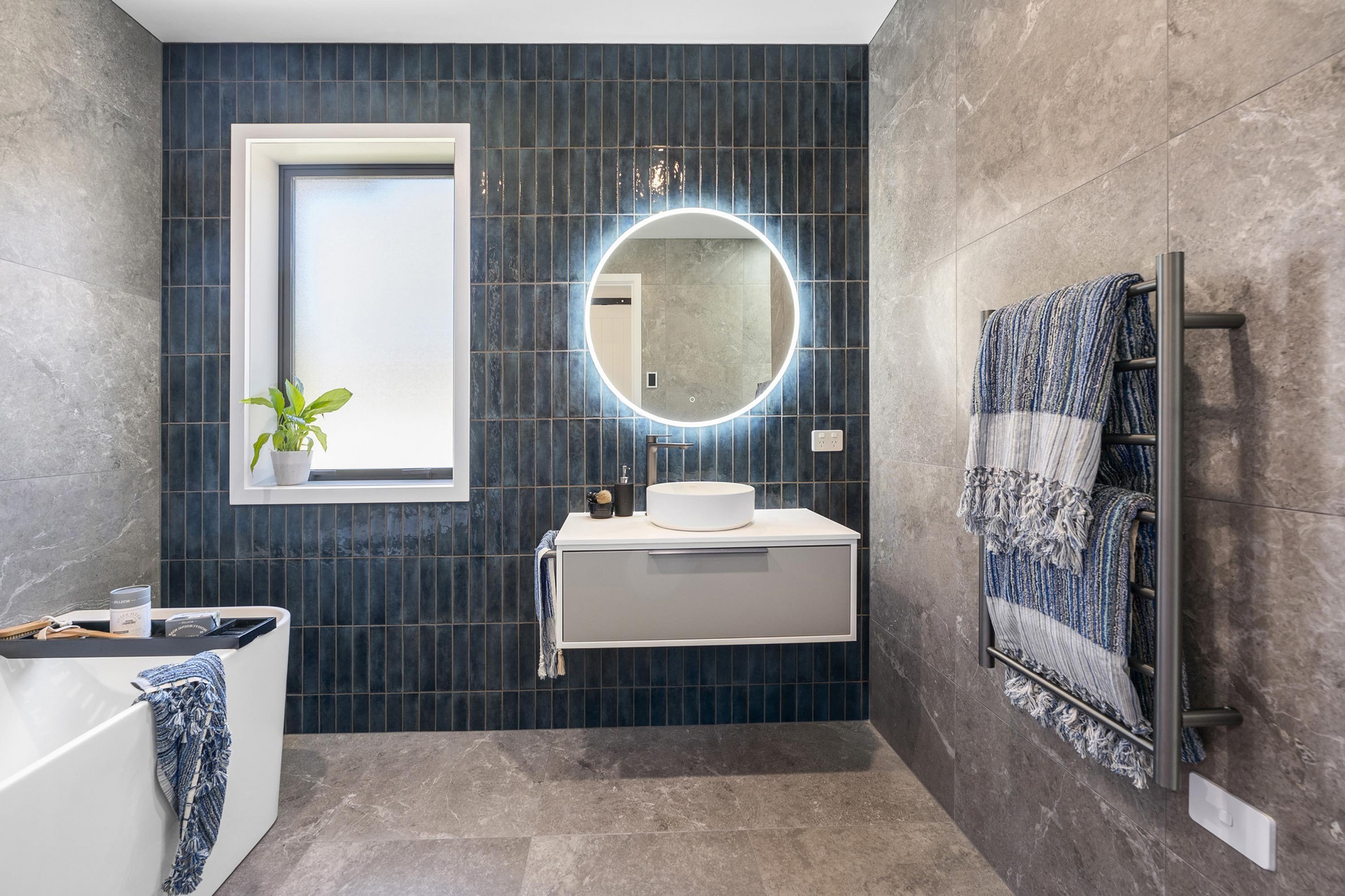 A bathroom with a sink, mirror and bathtub.