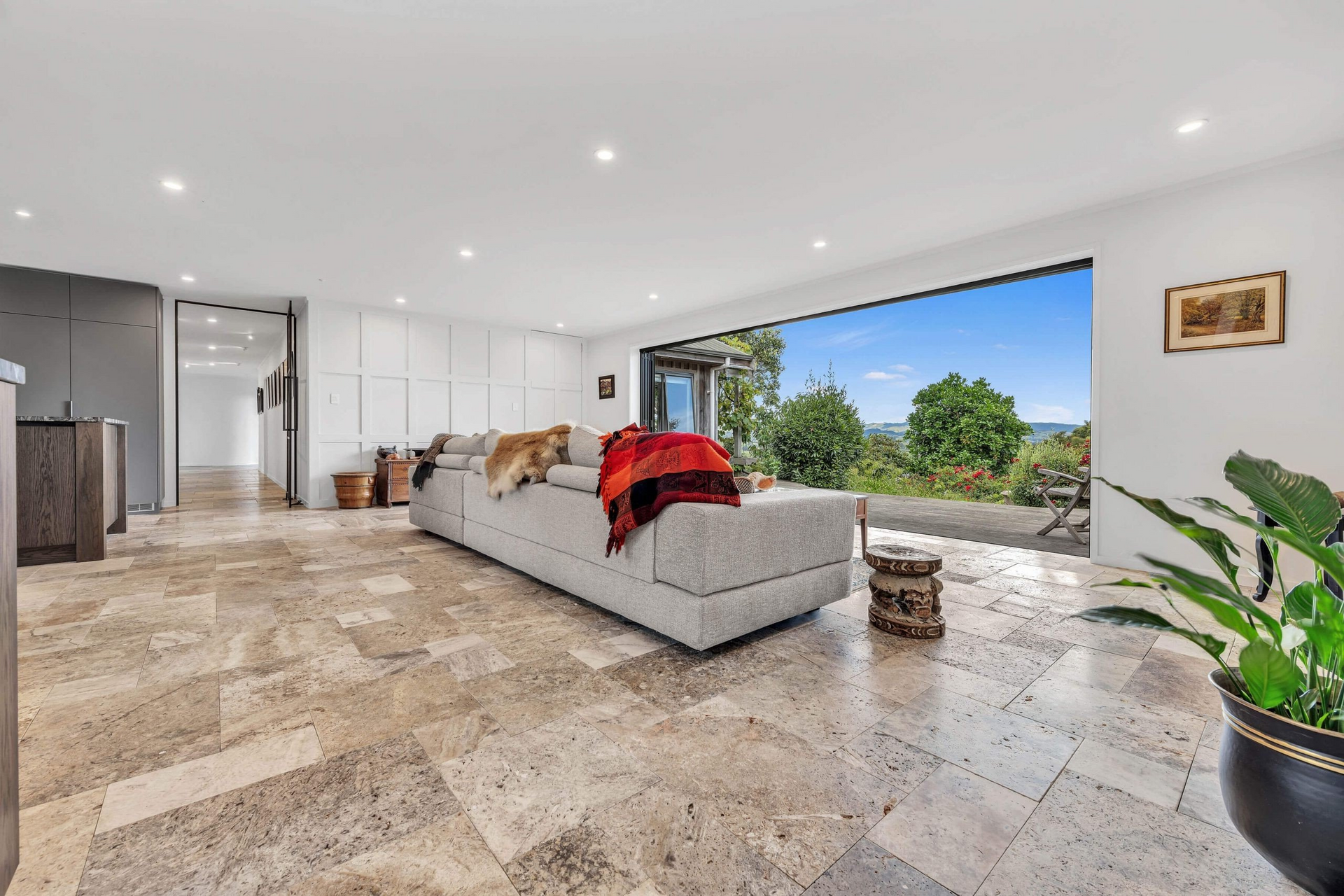 A living room with a large couch and a large window.