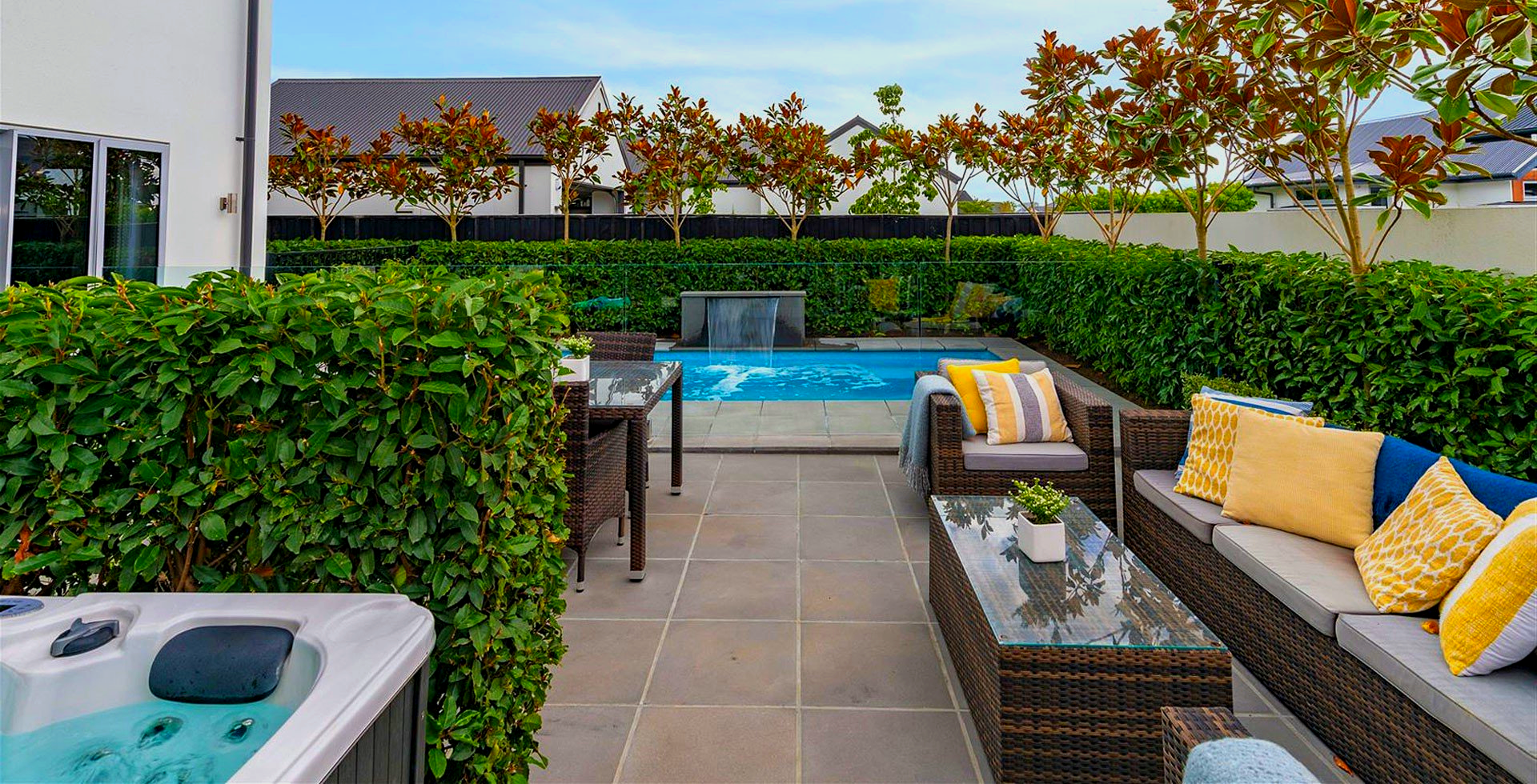 There is a hot tub in the backyard of a house.