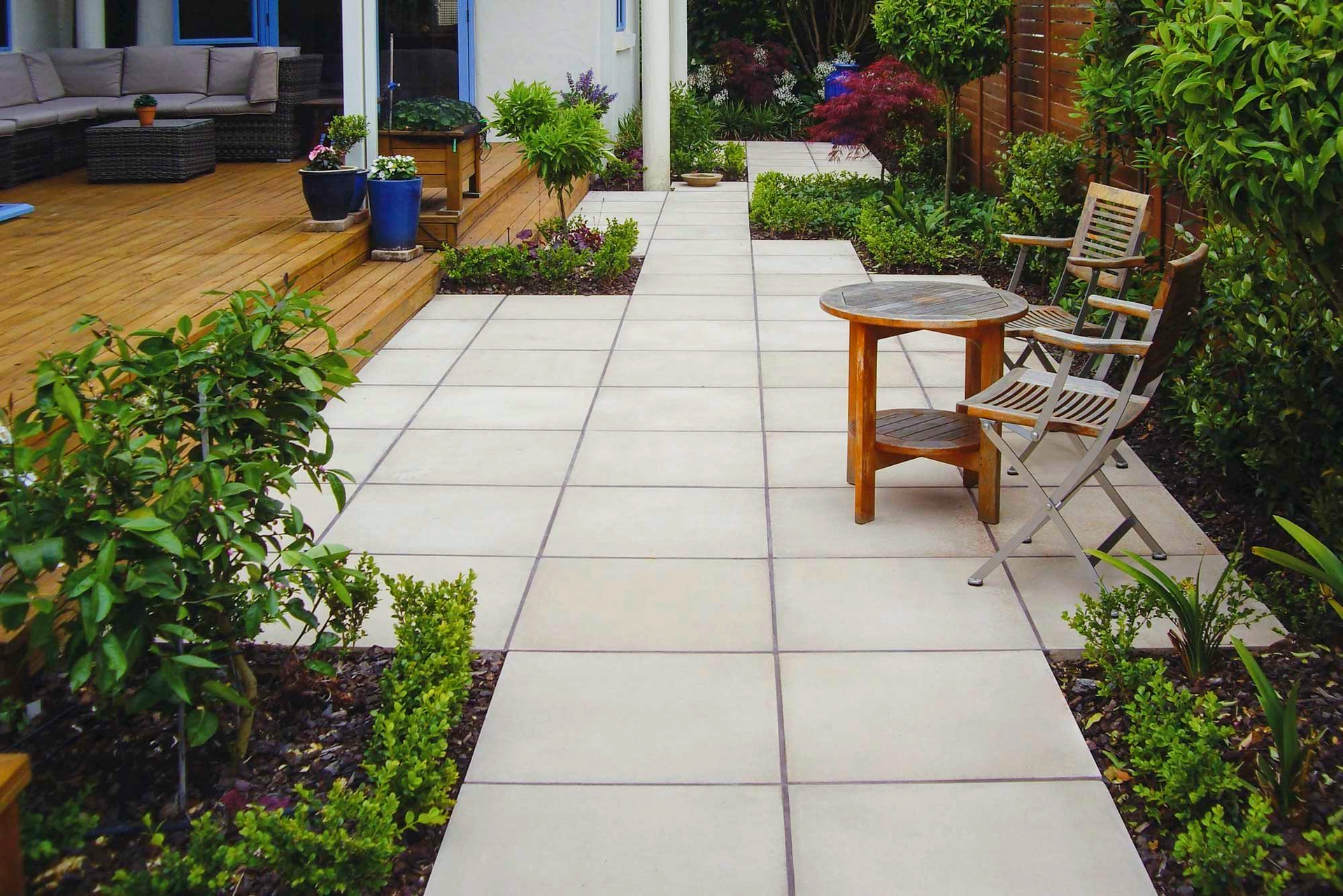 A patio with a table and chairs in it.