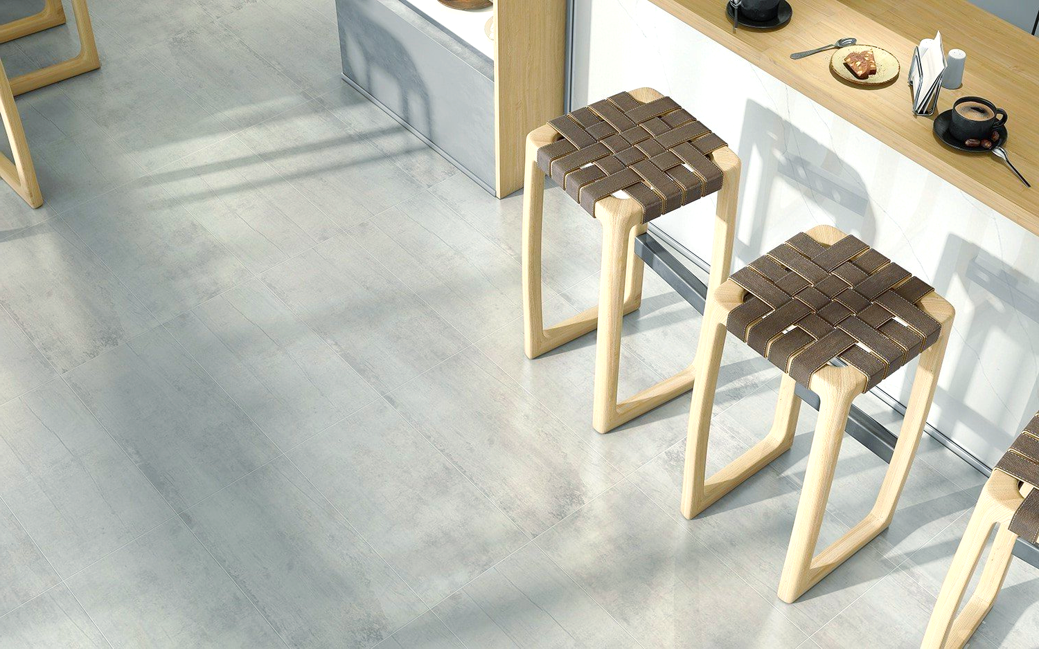 A row of wooden stools are sitting next to a wooden table.