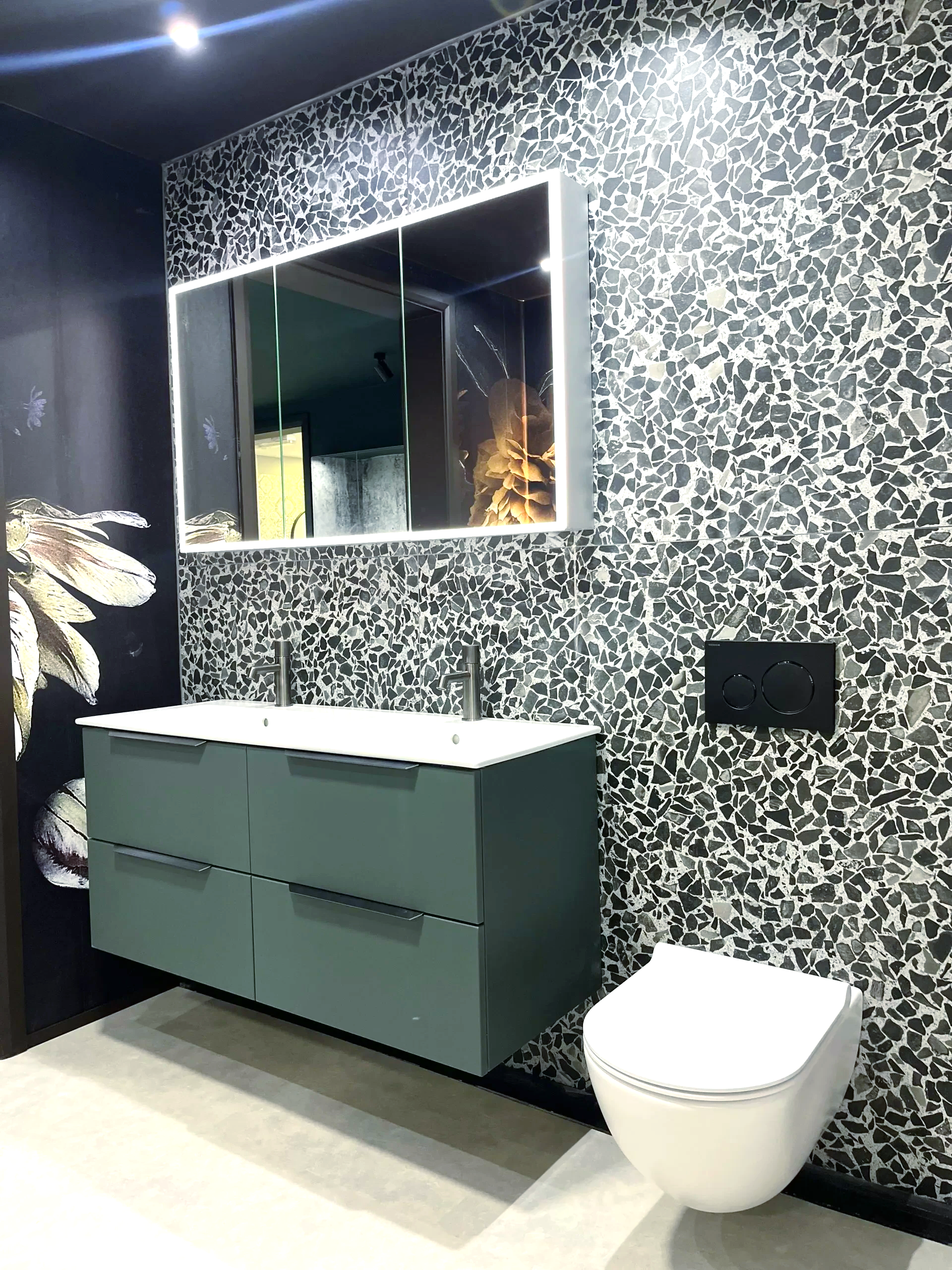 A bathroom with a sink, toilet and mirror.