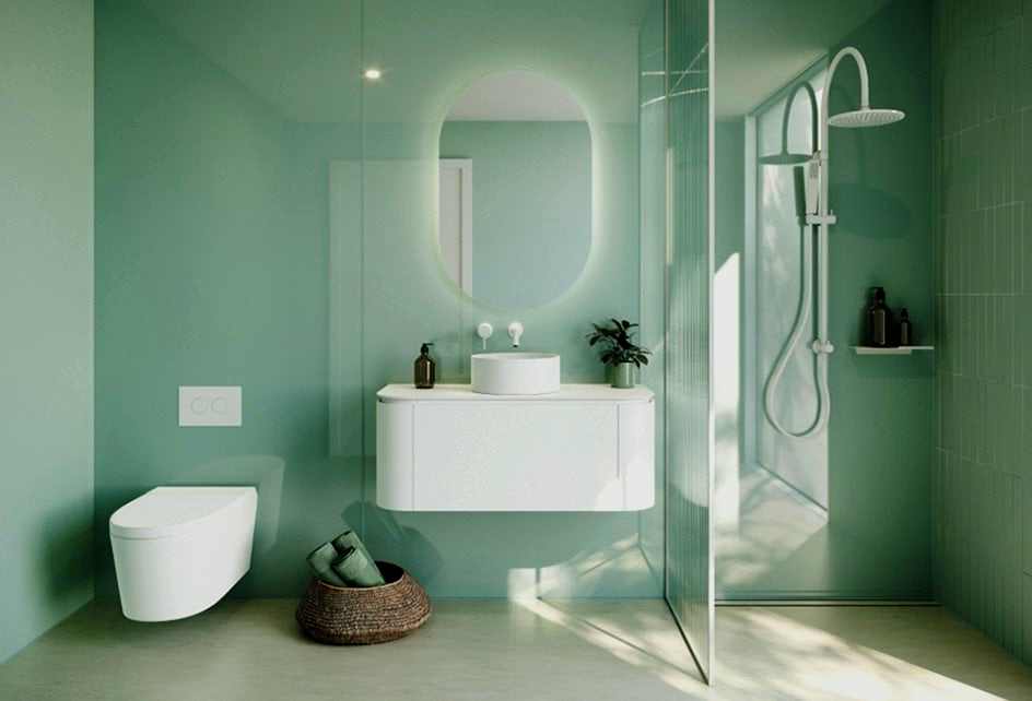 A bathroom with green walls, a sink, a toilet and a shower.