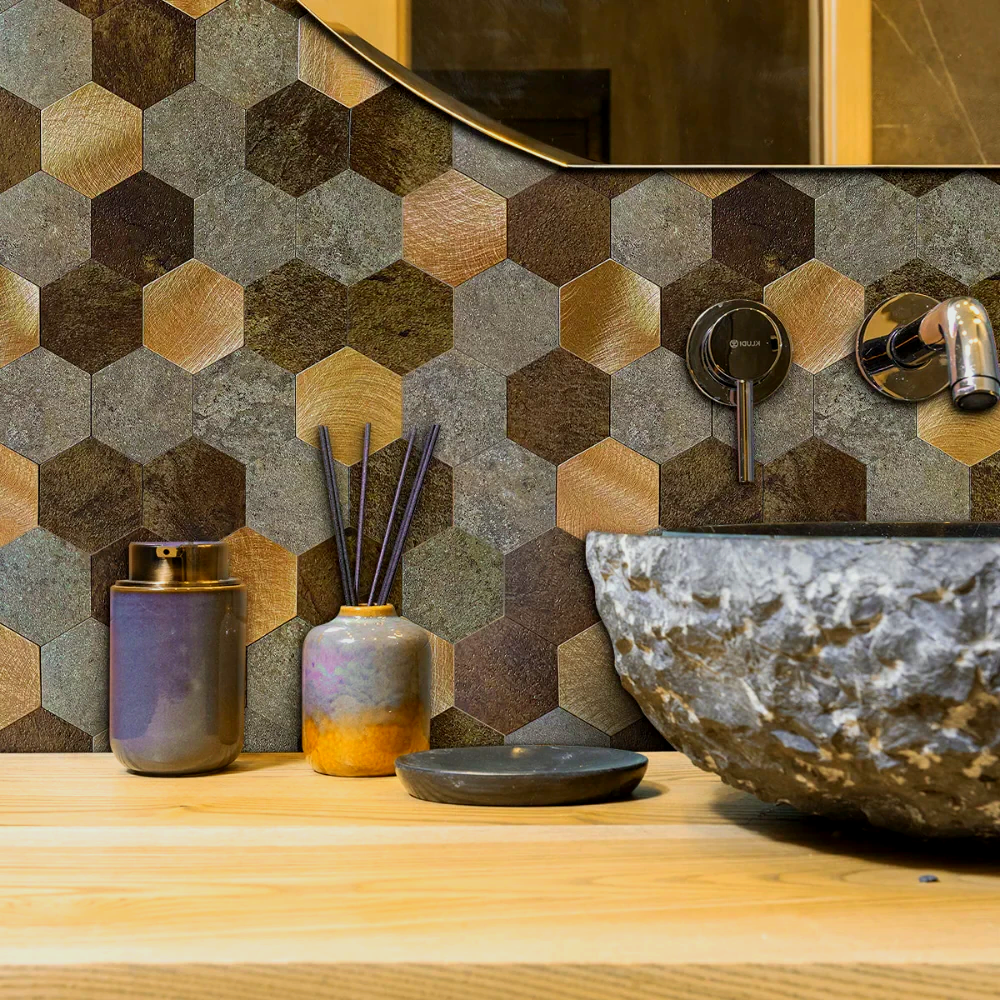 A bathroom with a sink, mirror, and hexagon tiles on the wall.