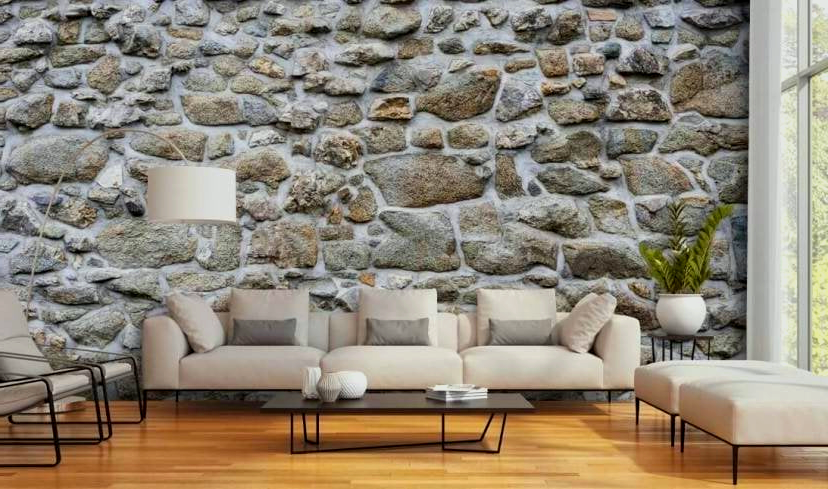 A living room with a stone wall and a couch.