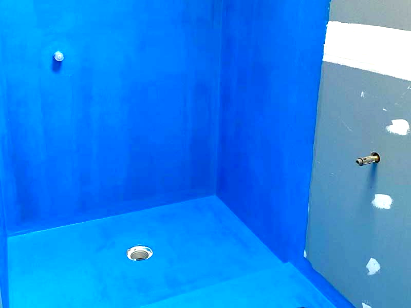 A work-in-progress bathroom with blue walls and a blue floor.