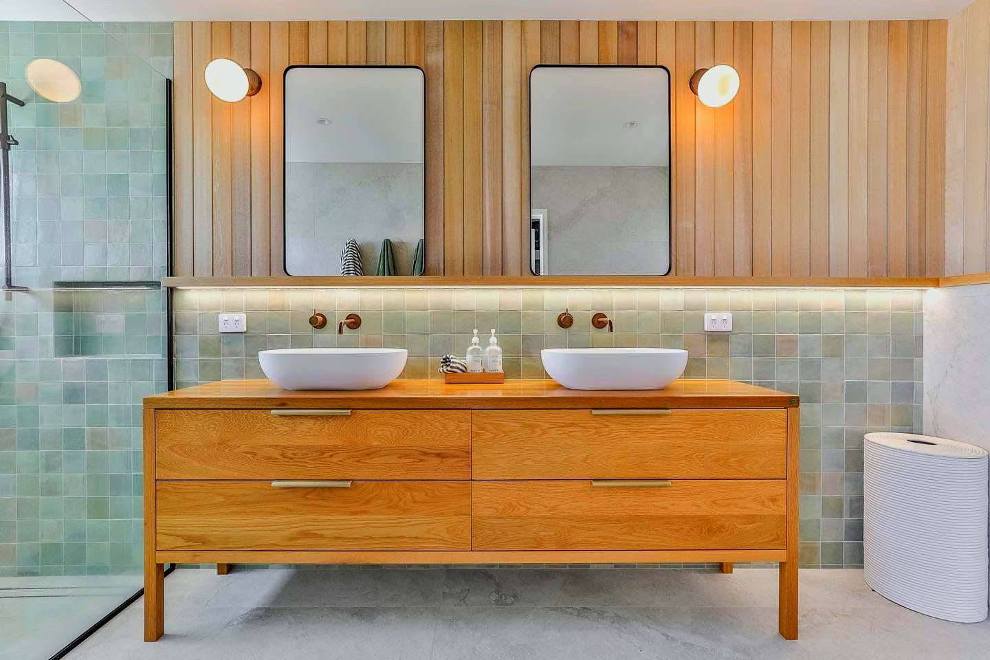 A bathroom with two sinks and two mirrors.