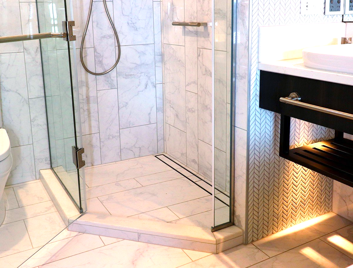 A bathroom with a walk in shower and a toilet.