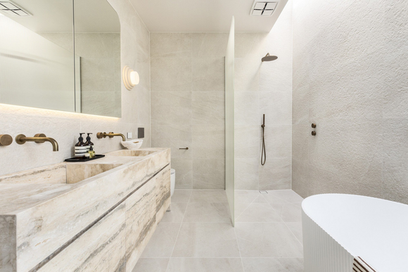 A bathroom with two sinks , a tub and a shower.