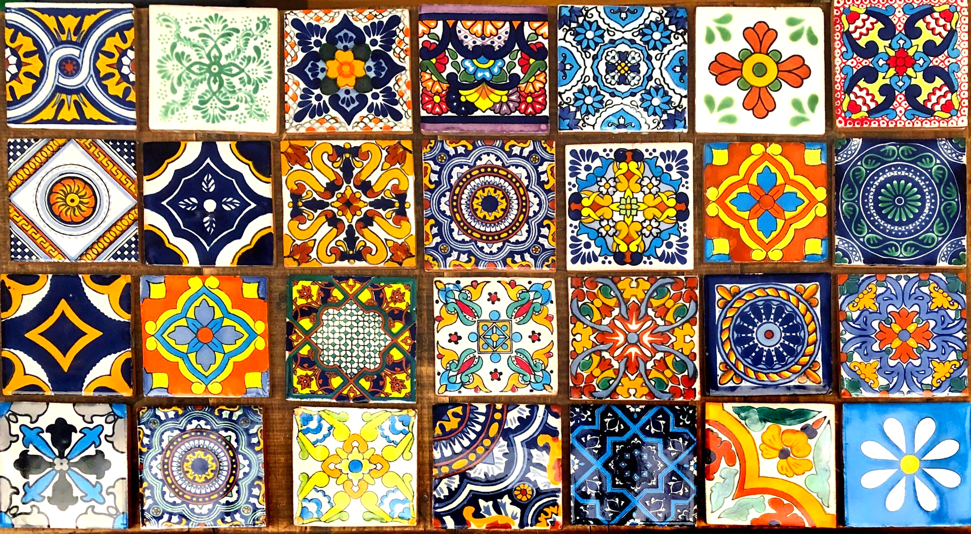 A bunch of colorful tiles with different designs on them.