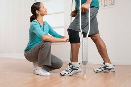 springwood physiotherapy and sports injuries centre physical therapist helping patient with crutches