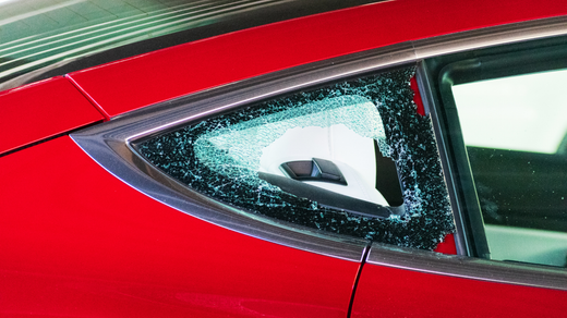 Red car with shattered rear window.
