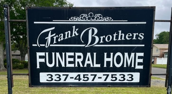 Sign for Frank Brothers Funeral Home with phone number.