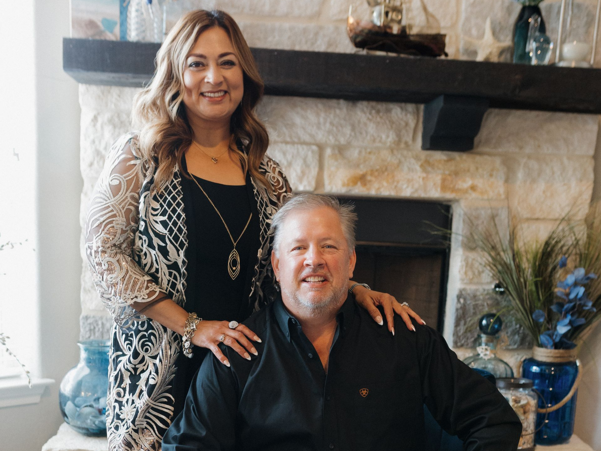 Two men are shaking hands in front of a statue of justice.