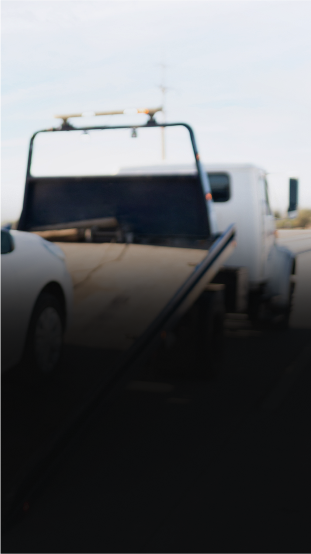 Tow truck towing a white car - Snap Towing & Recovery