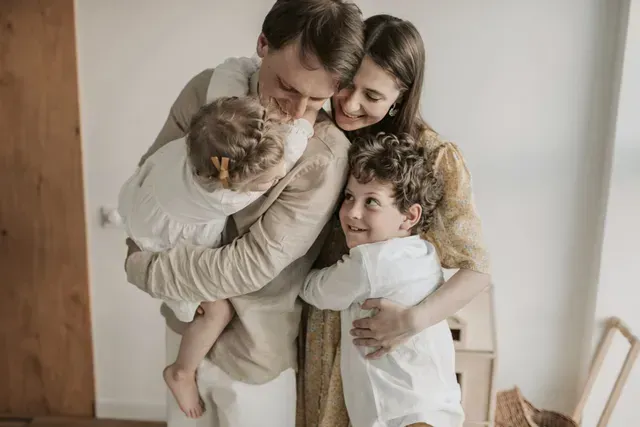 A family is posing for a picture together in a room.
