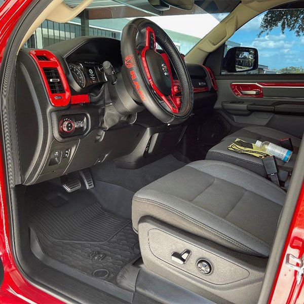 A red car with black seats and a red steering wheel
