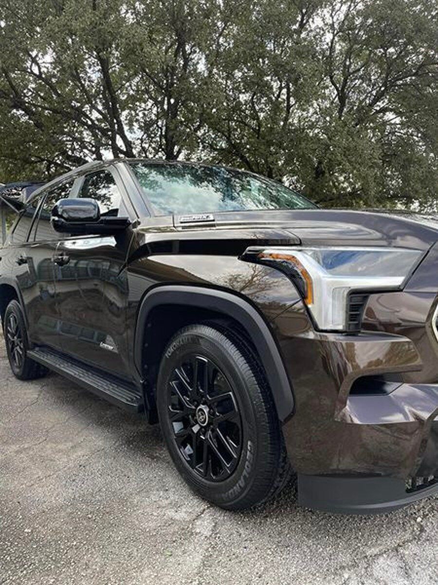A black toyota tundra is parked on the side of the road.