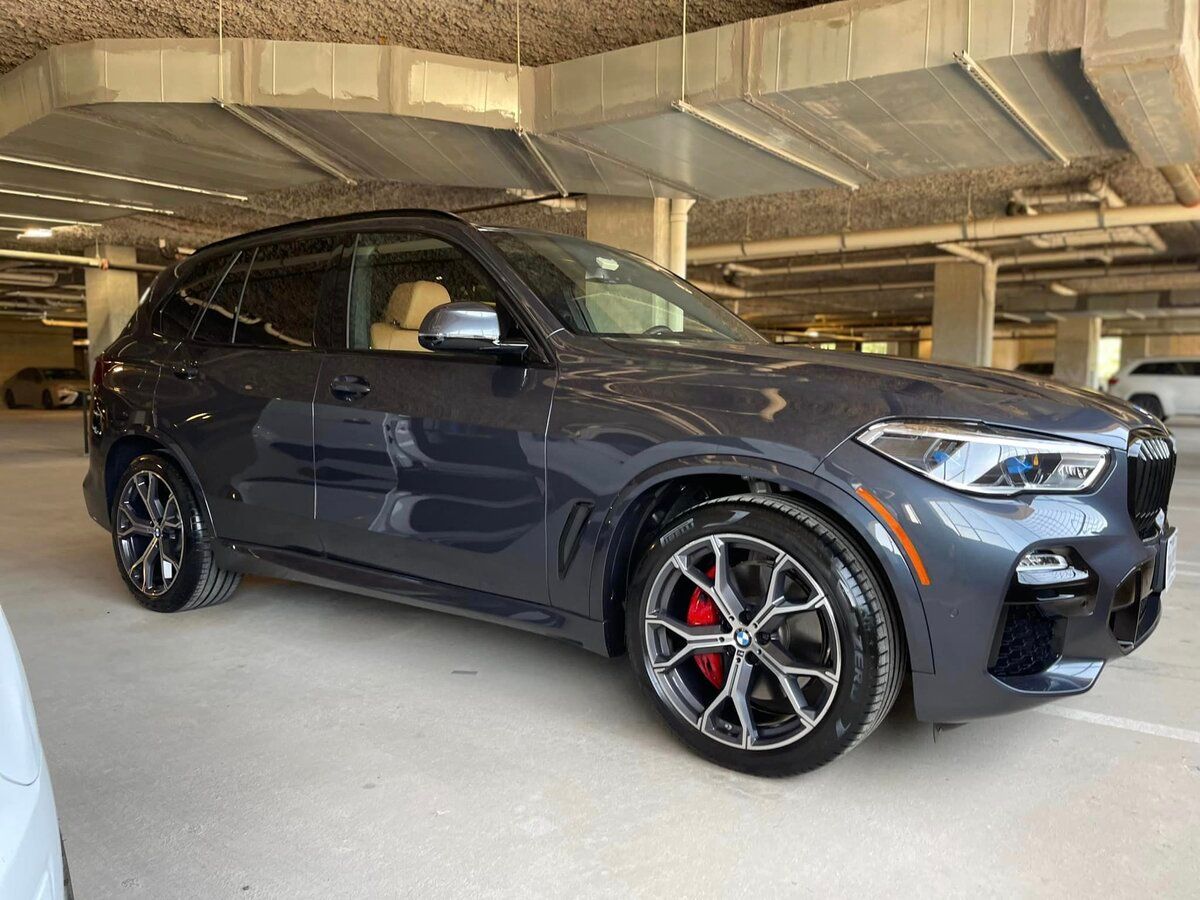 Sleek BMW SUV with red brakes