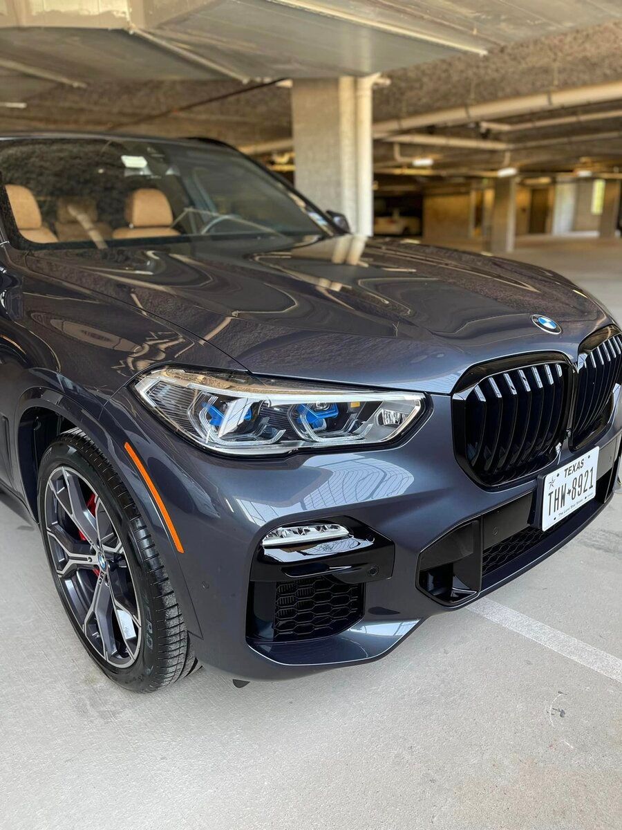 Shiny BMW SUV front view in garage