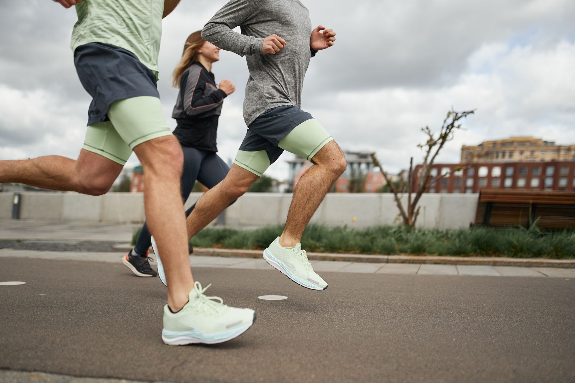 A Group Of People Are Running Down A Street | Conway, AK | The Sporty Runner