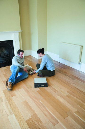 Laminate Flooring - Mike Baddeley Ltd - York, Yorkshire - couple sitting on laminate flooring