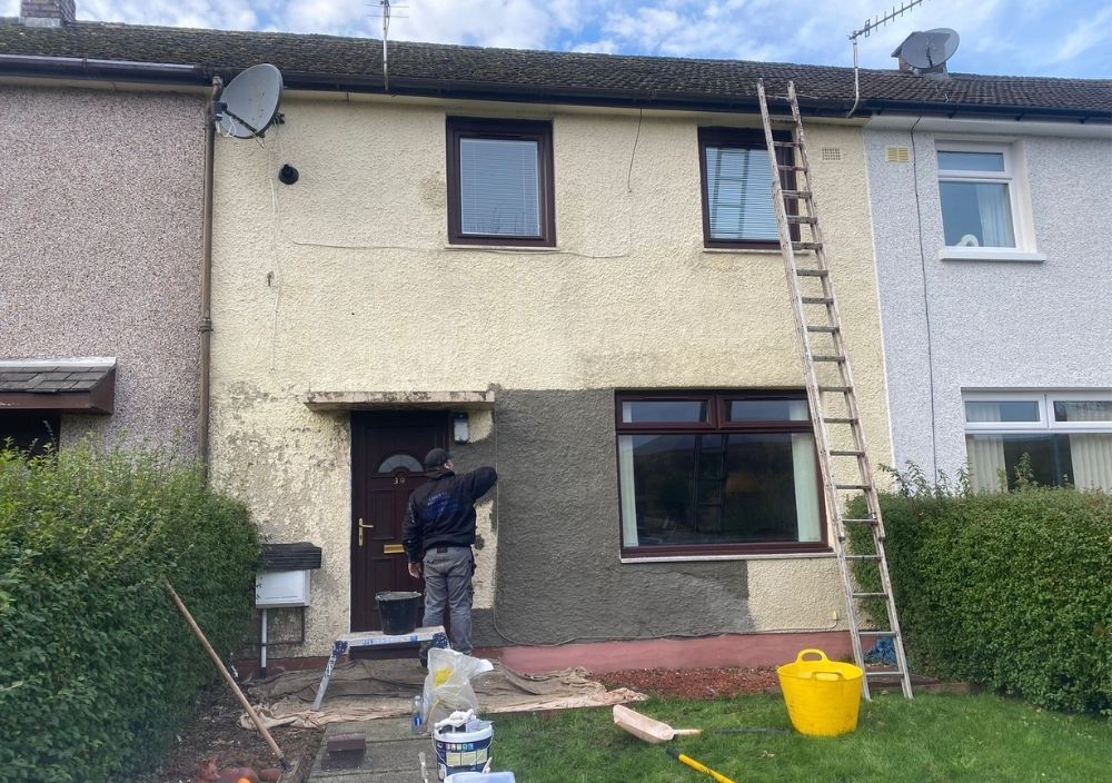 Liberty Painters and Decorators painting exterior walls grey of a house in Belmont Ayrshire