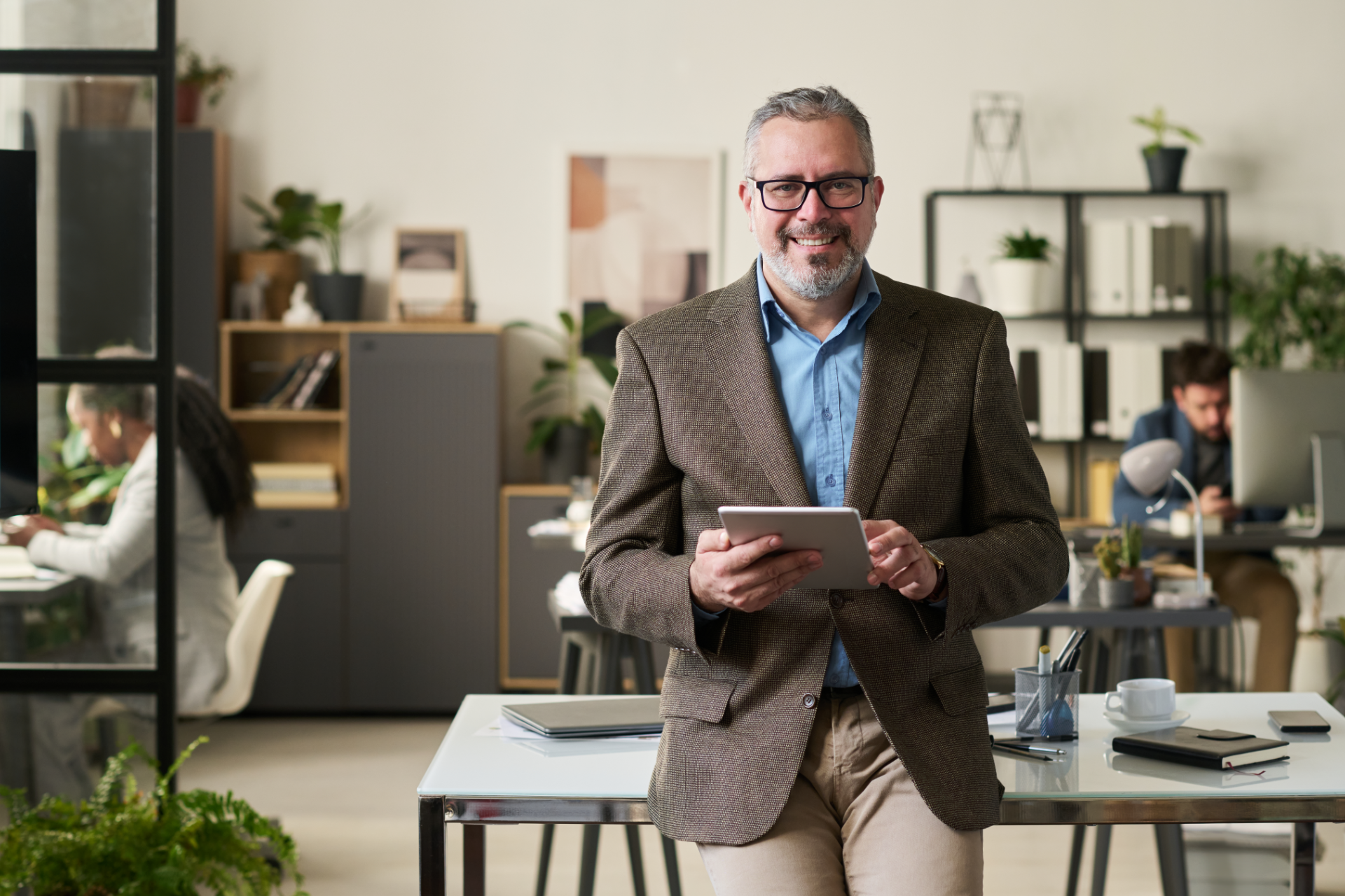 Man in plaid shirt smiles at child from car window.
