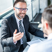 Family smiles inside a car, driving on a sunny day.