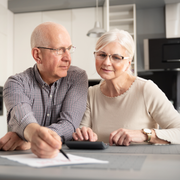 Family smiles inside a car, driving on a sunny day.