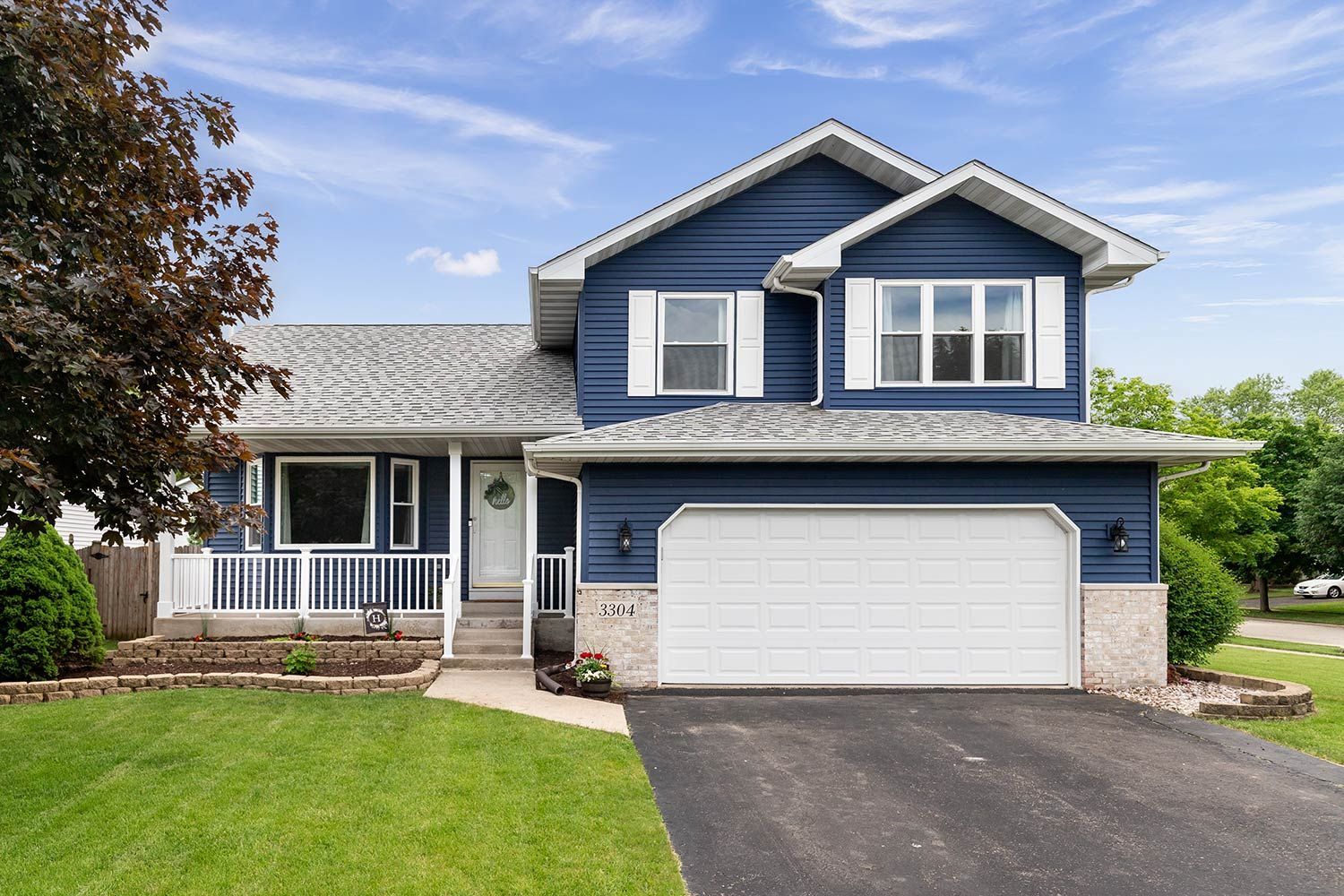 A blue house with shingle roof
