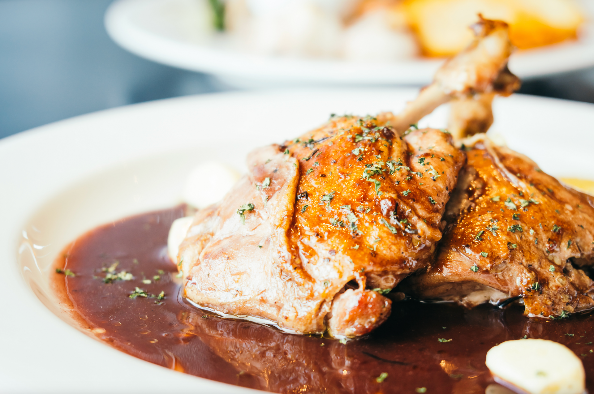 A close up of a plate of food with meat and sauce