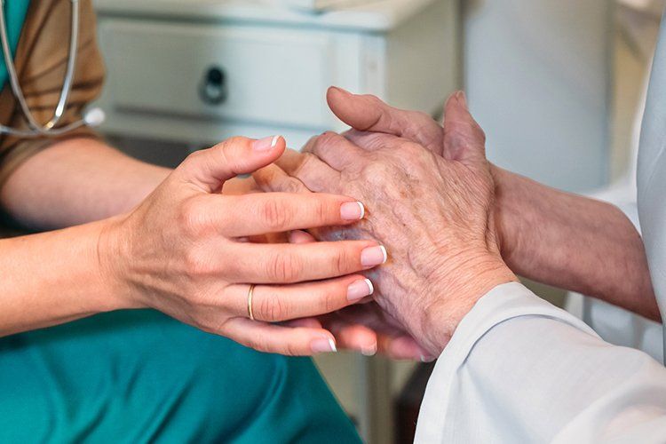 Doctor Holding the Hands of the Patient  — Columbia, SC — Johnson Toal & Battiste PA