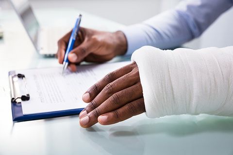Injured Man Filling Insurance Claim Form — Columbia, SC — Johnson Toal & Battiste PA