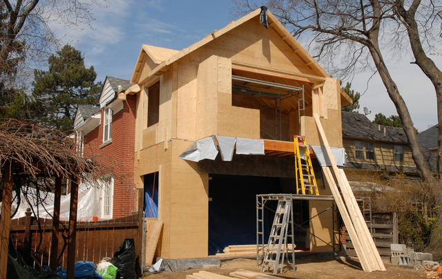 A house that is being built with a lot of wood