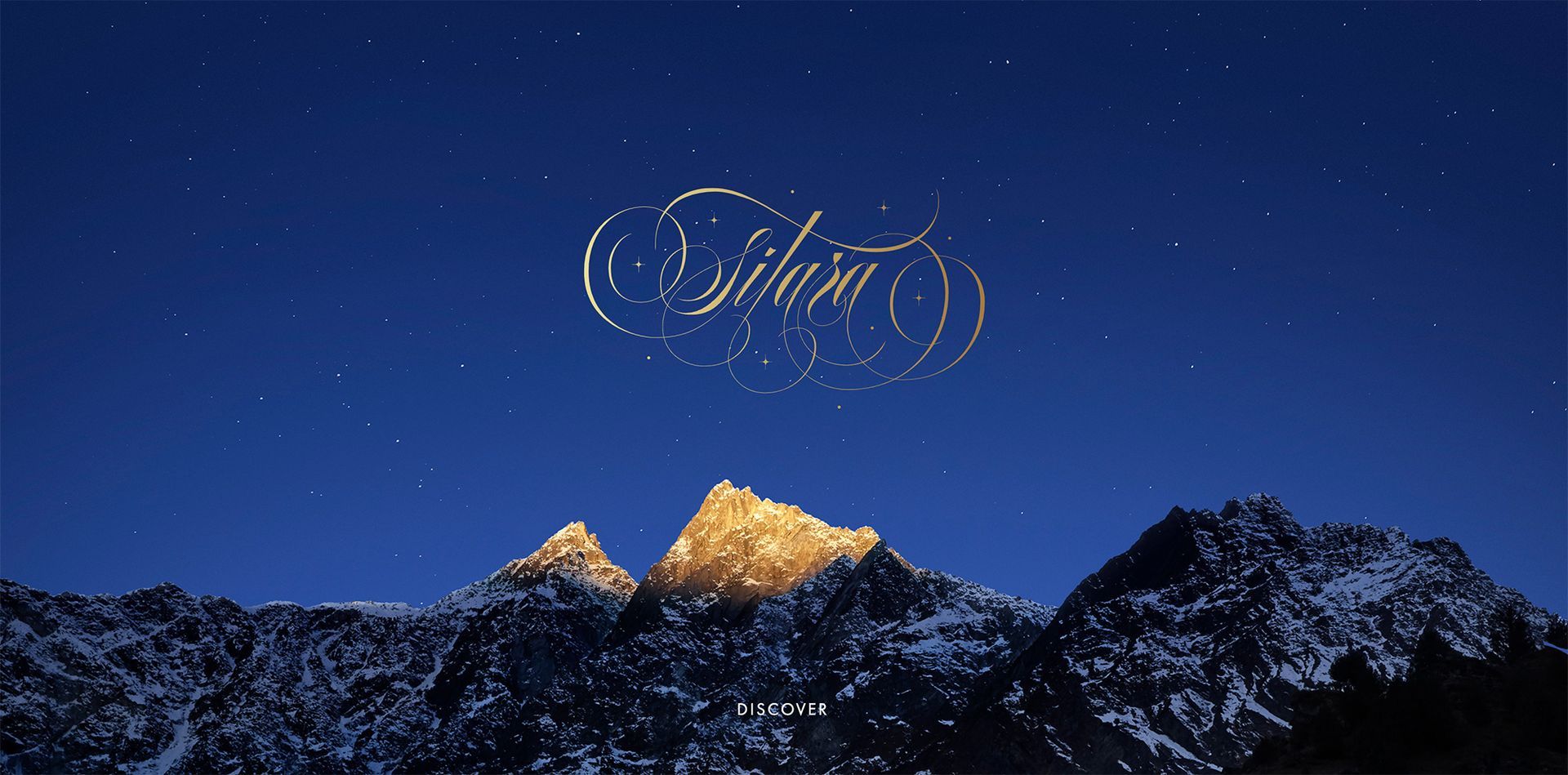 Star logo above snowy mountain peaks under a deep blue night sky