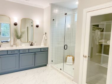 Overall modern master bathroom renovations in Wollongong NSW with glass and tiled wall in shower.