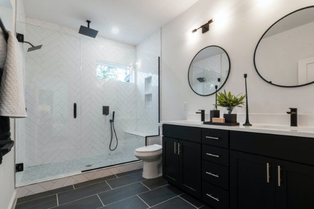 A newly renovated shower space in white and black colour theme, shower renovations done by the expert renovators in Wollongong NSW.