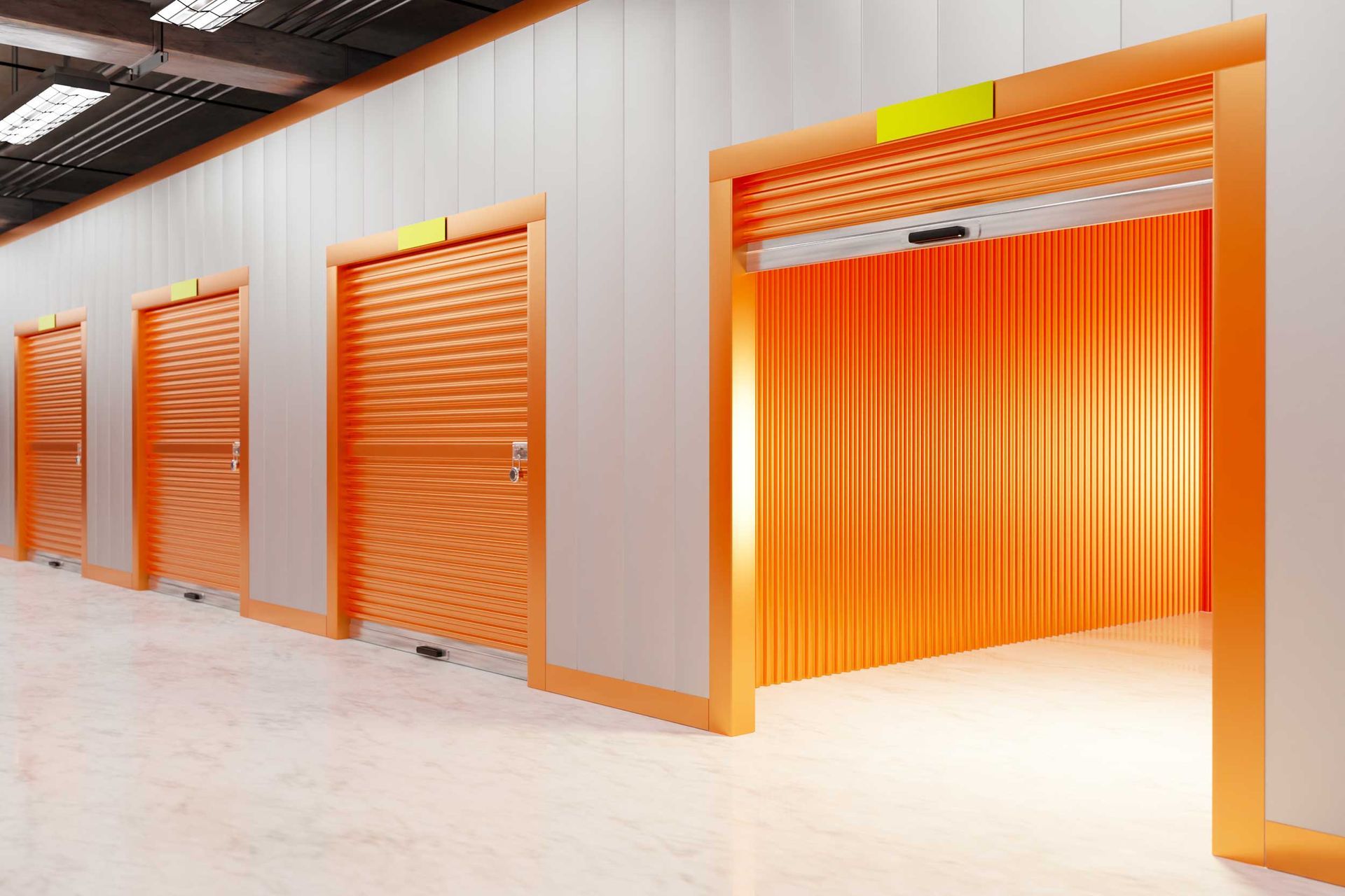 Mini storage unit with orange roll-up door inside self-storage facility. Mini storage unit with orange roll-up door inside self-storage facility.