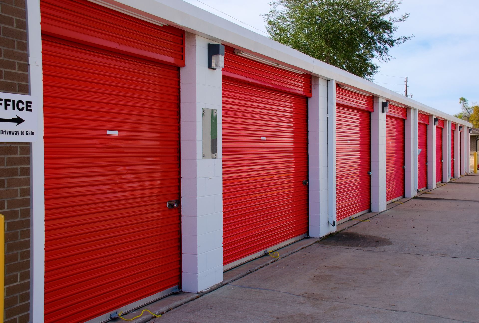 Open storage unit filled with boxes, furniture, and household items.