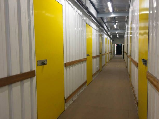 Corridor full of yellow doors in unrecognizable self-storage place.