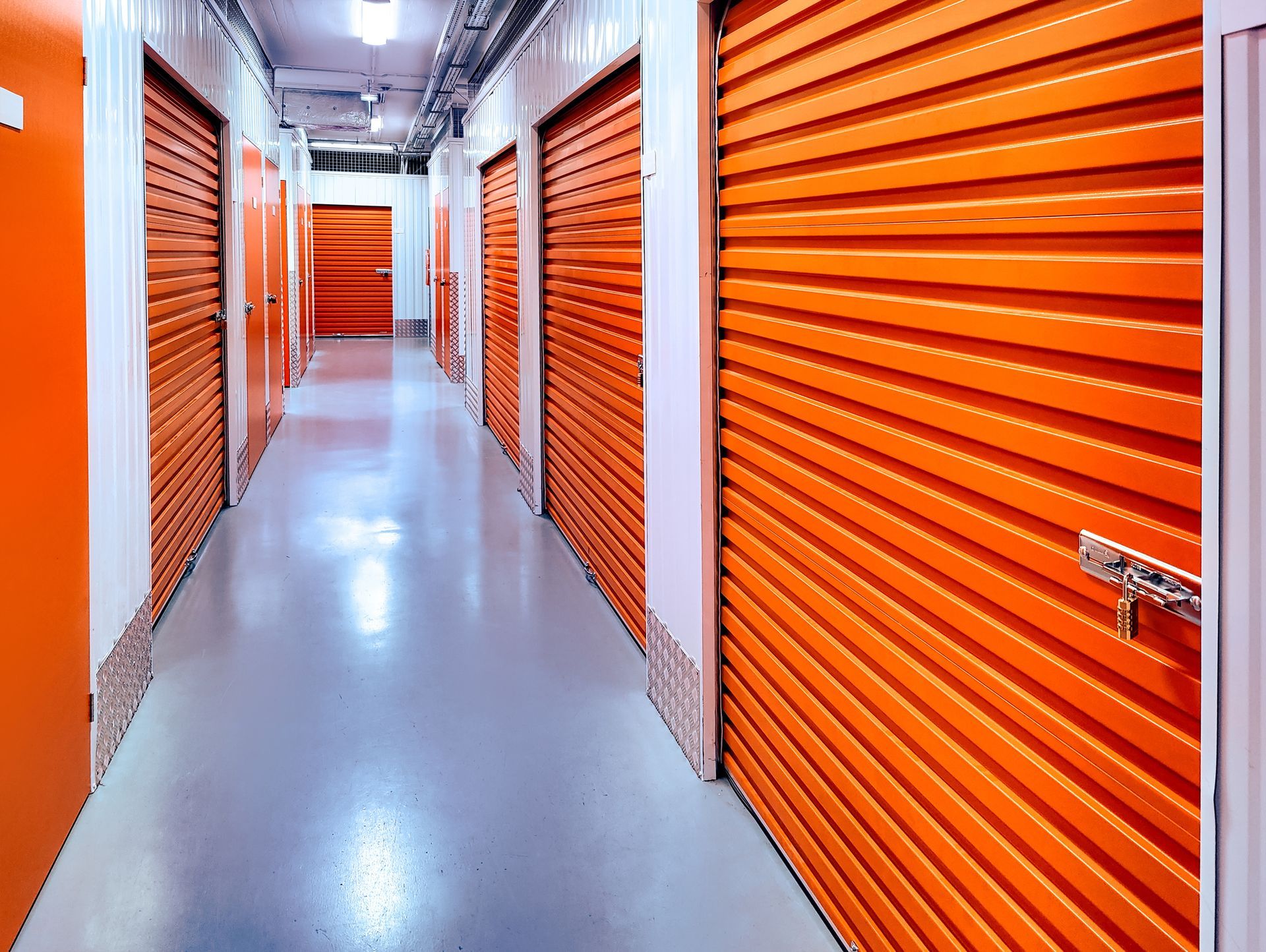 Alley of indoor closed self-storage units.