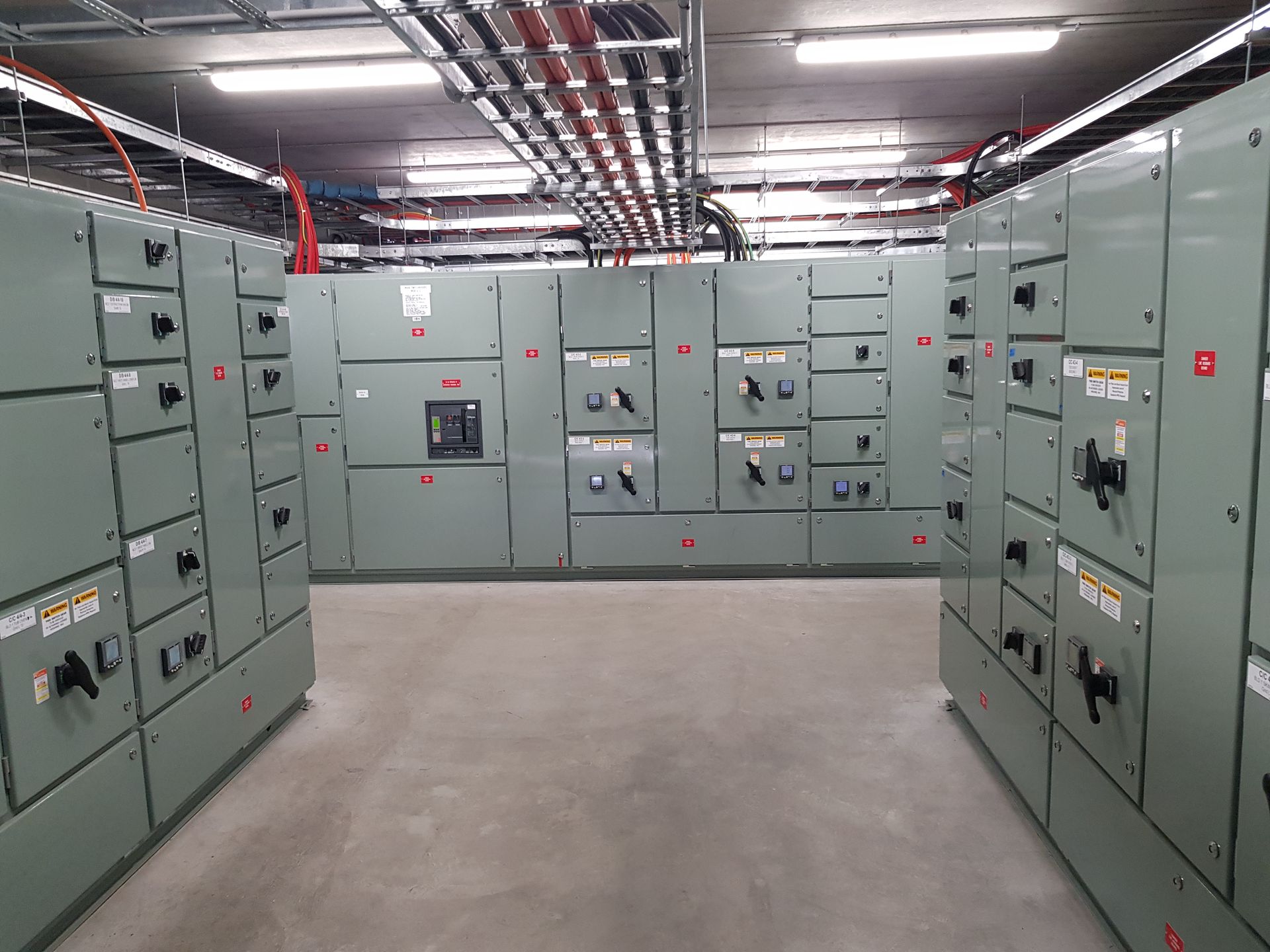 A row of orange electrical boxes in a room
