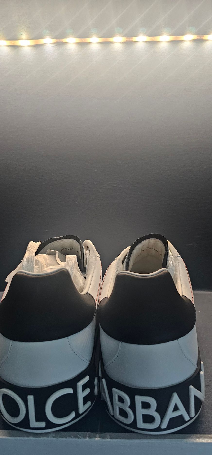 White and black Dolce & Gabbana sneakers on display