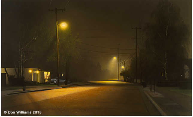 Street scene at night with fog. Streetlights illuminate an empty road, creating hazy shadows.
