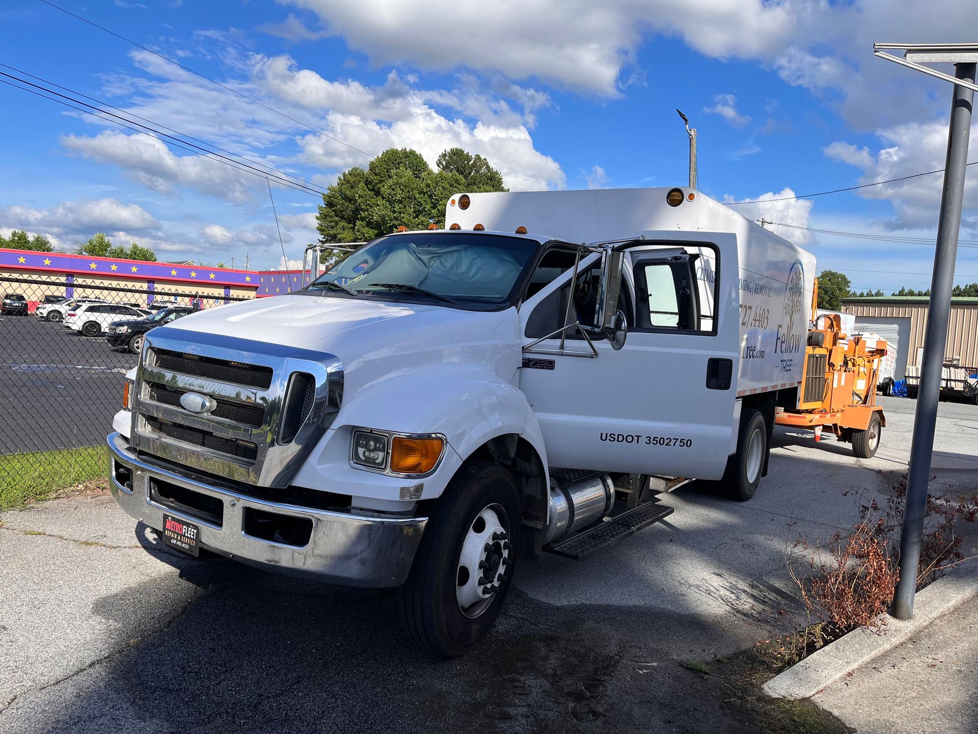 A white truck is parked on the side of the road.