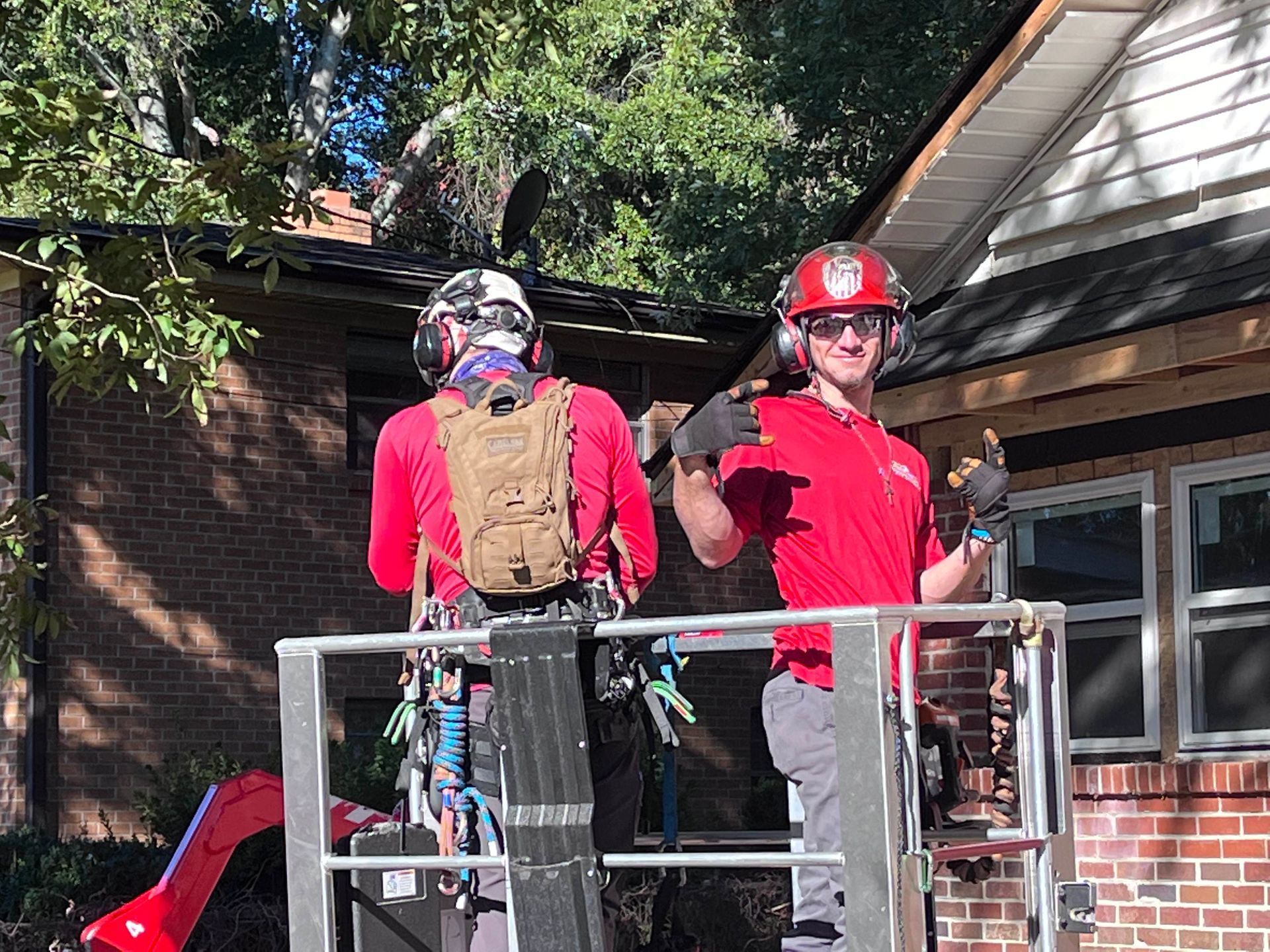 Two men are working on the roof of a house.